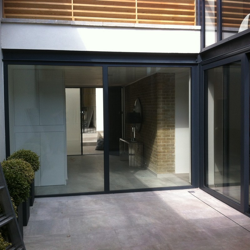 Floor-to-ceiling sliding doors opening to courtyard in Westcombe Park