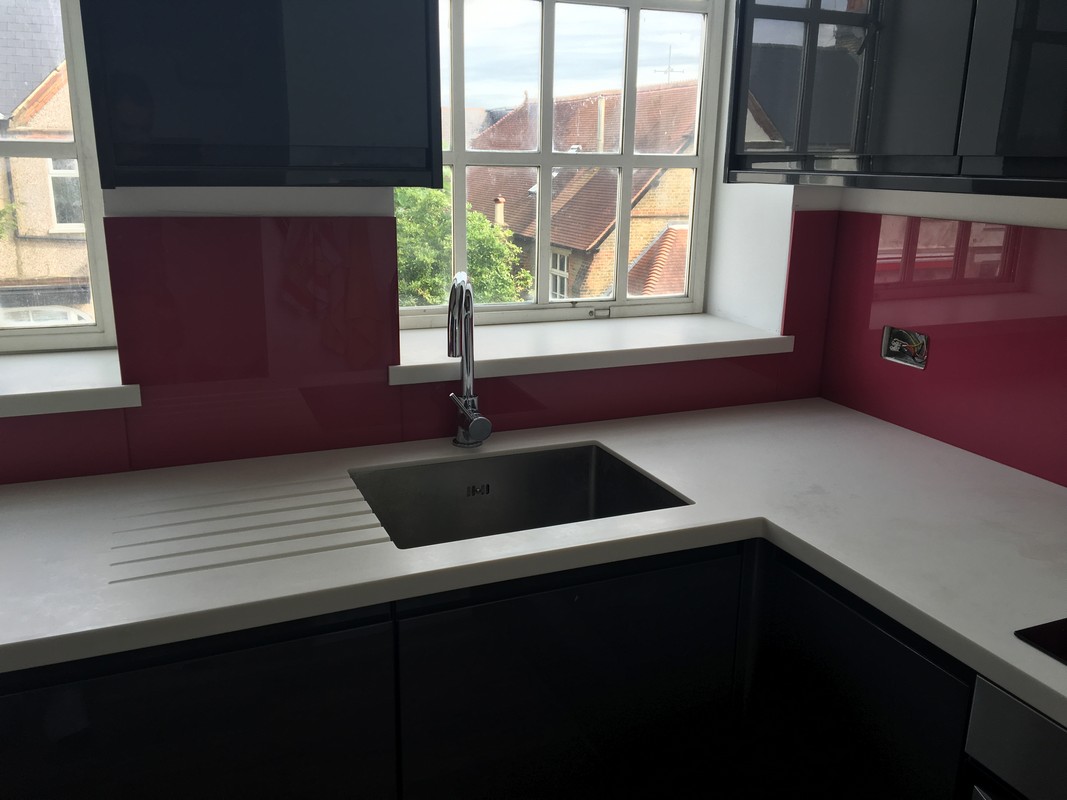 Deep plum coloured glass splashback in modern Westcombe Park kitchen